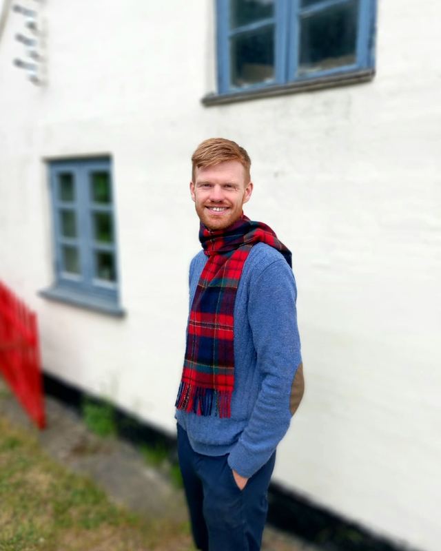 Ian McPherson outside a whitewashed island house